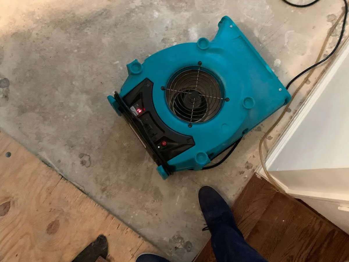 Air mover drying subfloor during Commercial Water Damage Restoration in Cheyenne